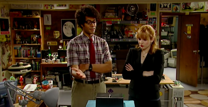 Scene from TV series "The IT Crowd" where Moss shows a black box with a LED and says "This, Jen, is the Internet"