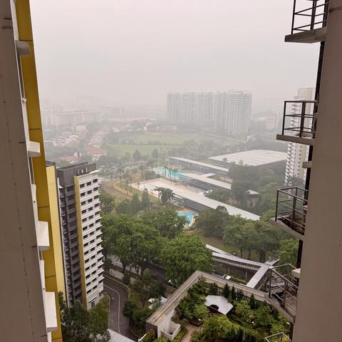 Photo of haze obscuring many buildings and impacting visibility from a high rise building in Singapore