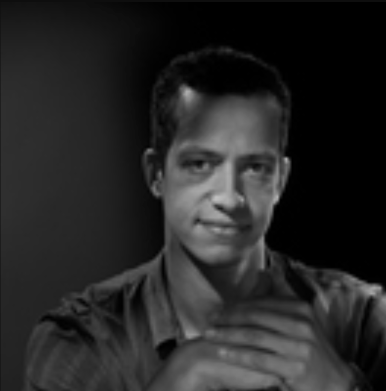Dominique Hazaël-Massieux, a man with short curly hair with his hands folded in front of him